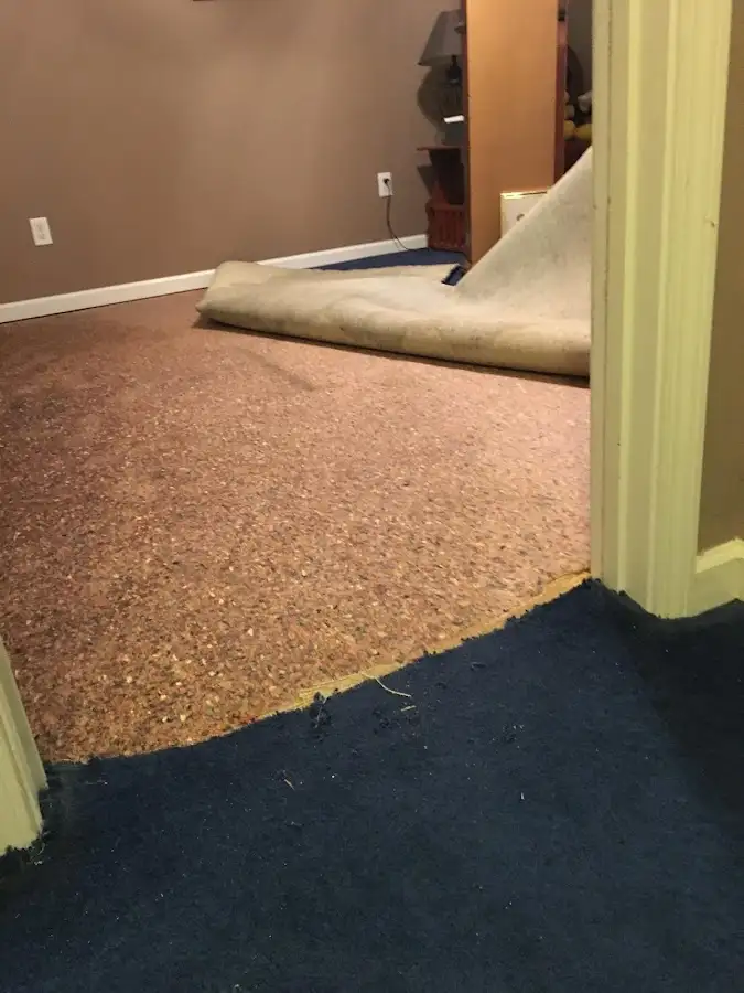 Carpet pad removal revealing water damage during Water Mitigation Services in Leland